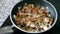 Close-up of delicious fried mushrooms with onion in a frying pan