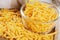 Close up of delicious Grated Cheddar Cheese on wooden background