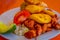 Close up of delicious hornado, ecuadorian traditional typical andean food served with corn, potato, sweet plantain