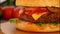 Close-up of a delicious mouth-watering cheeseburger with beef cutlet
