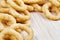 Close up of delicious onion rings on wooden cutting board