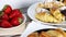 Close up of delicious pastry stuffed with cherries, croissants and fresh strawberries served on the table