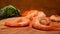 Close-up of delicious peeled shrimps falling on the wooden board