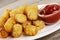 Close up of delicious Tater Tots on a wooden background