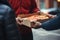 Close-up of delivery man giving pizza to woman in city street, Man delivery pizza to a customer, top section cropped, AI Generated