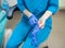 Close-up of dentist female putting on blue disposable gloves