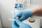 Close up on dentist hands covered with latex gloves shaping mouth guard with file equipment