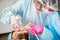 Close-up of dentist and her assistant working with patient teeth