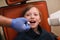 Close up of dentist putting intraoral shield to children patient mouth and assistant directing x-ray machine at dental clinic