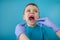 Close up of dentist`s hands with assistant in blue gloves are treating teeth to a child, patient`s face is closed