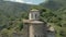 Close up Departure on the dune around the ancient dilapidated Christian church standing high on the mountain. Erial View