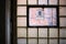 Close-up of a desolate and dirty factory window made of glass bricks