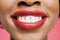 Close-up detail of an African American woman smiling over colored background