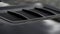Close up for detail of air vents on the bonnet of a modern black car. Stock. Car exterior background detail of air