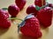 Close up detail artificial strawberries and cherries fruit isolated on orange background