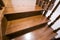 Close-up detail of brown wooden oak stairs in new renovated house. Staircase between two floors