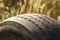 Close-up detail of car wheel tire badly worn and bald because of poor tracking or alignment of the wheels.