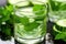 close-up detail of cucumber slices and mint in a transparent glass