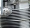 Close up detail of the cylinder head of an old motorcycle with silver fins and chrome bolts