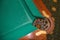 A close-up detail of a luxurious billiard table with a pocket for balls of their leather and metal, a copy of the space