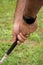 Close-up detail of man`s hands with black digital watch, holding golf club,