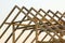 Close-up detail of new attic wooden roof frame against clear sky. Professional building, roofing, construction and renovation conc