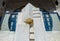 Close-up of detail of old grungy art deco building with round window about stucco entryway