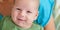 Close-up detail portrait of cute little peaceful smiling baby boy face