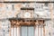 A close up detail shot of an ancient and historic sandstone building facade