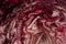 Close up, detail shot and background of radicchio. The vegetables are red and white and are sliced. The vegetables are in the