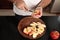 Close-up detail shot of Caucasian man`s hands cutting apples into pieces. Top view