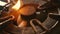 Close up detail shot of old rusty kitchen stove ring switched on fire with lighter flame burning in dangerous gas energy and