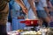 Close up detail shot of person\'s arm stirring a traditional tasty delicious pot of hot melted liquid swiss cheese fondue