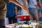 Close up detail shot of person\'s arm stirring a traditional tasty delicious pot of hot melted liquid swiss cheese fondue