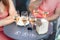 Close-up detail table with many filled glasses of white champagne prosecco at party celebration event outdoors. People having fun