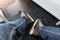 Close-up detail view of male person legs wearing jeans and black rental skating boots standing on non-slip rubber soft