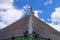 Close-up detail view of weather vane. Abstract outdoor view of the top of an ancient house roof made of grey slates