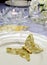 Close up of detail on wedding breakfast dining table setting with gold butterfly on china plates