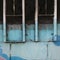 Close-Up Detail of a Window and Mural on an Old Urban Building Exterior Wall.