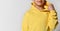 Close up detail of a yellow sports hoodie dressed on a little boy. White background.