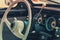 Close-up, detailed photo of the interior, dashboard and speedometer of a classic oldtimer car.