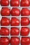 Close up detailed top view background wallpaper shot of rows and lines of large tasty red ripe tomatoes in a white crate box