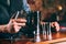 Close up details of barman hands using cocktail tools. Professional bartender working at bar