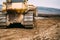 Close up details of bulldozer pushing earth and leveling ground on construction site