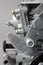 Close up of details of car carburettor against gray background