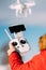 Close up details of drone remote control and white drone in blue sky. Man operating drone, pilotage details