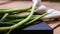 Close up of details of fresh green onions scallion on a cutting board isolated