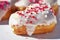 Close-up details of Heart-shaped donuts with tiny red heart sprinkles
