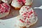 Close-up details of Heart-shaped donuts with tiny red heart sprinkles