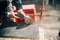 Close up details of worker cutting stone marble with angle grinder at construction site